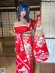 A woman in a red kimono posing for a picture.