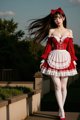 A woman in a red and white dress is posing for a picture.