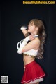 A woman in a red and white outfit posing for a picture.