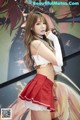 A woman in a red skirt and white top posing for a picture.